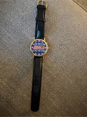 Jeopardy Black Leather Strap Wristwatch with Gold Case and Patterned Dial